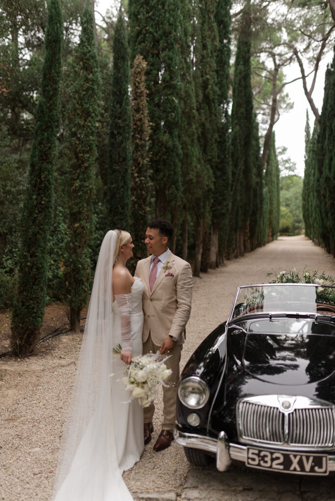 Bride & Groom with a vintage car in a castle